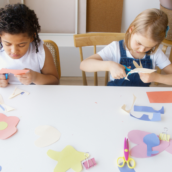 two girls cutting as an early finisher activity. 