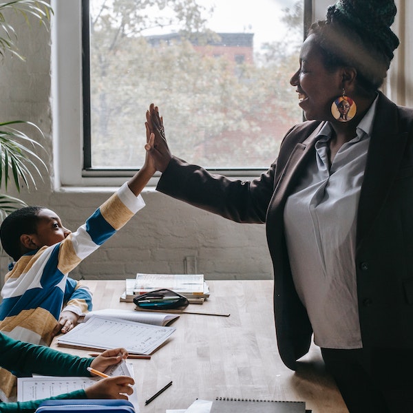 teacher high fiving her student