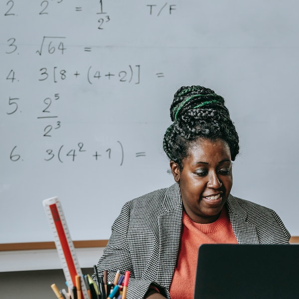 teacher sitting in front of computer